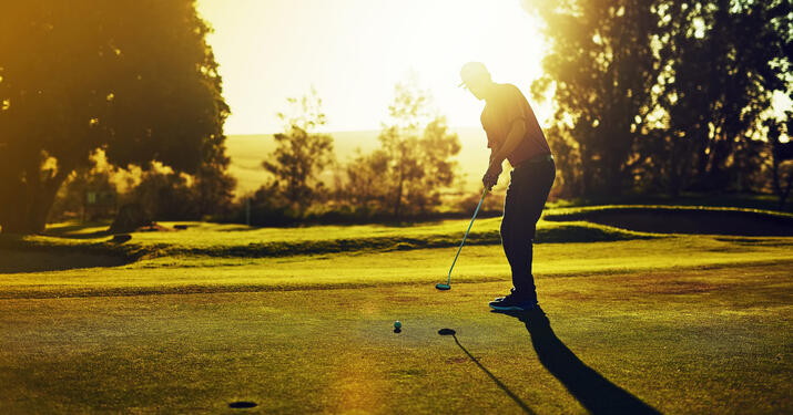 person golfing